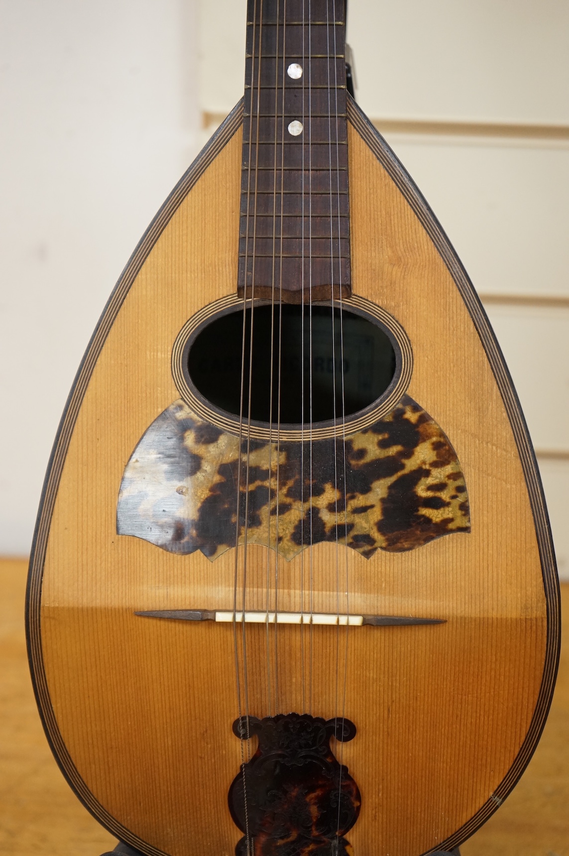 An early 20th century Italian cased mandolin by Carlo Ricordo, Napoli, with spruce soundboard inlaid with tortoiseshell